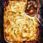 sausage pie topped with mashed potatoes in ceramic oven dish