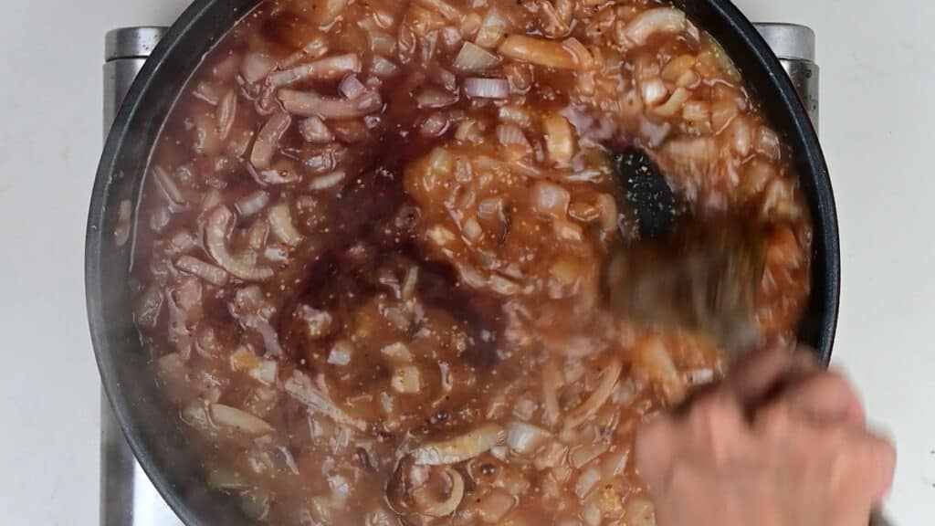 Making onion gravy in a pan