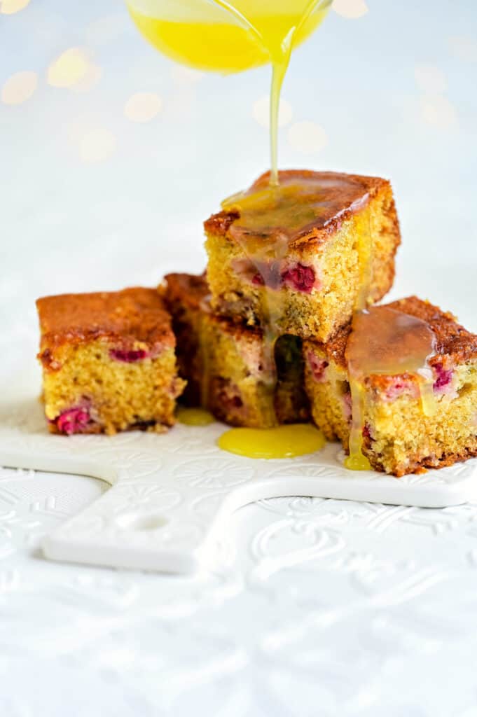 Cranberry cake squares on a ceramic board