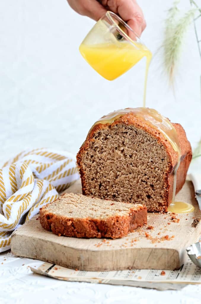 Drizzling Mary Berry Banana Loaf with butter sauce