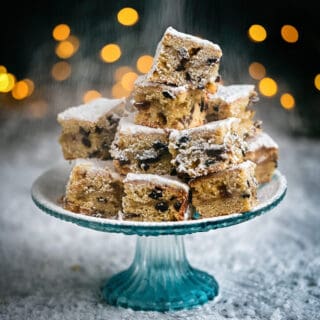 Stollen bites dusted with icing sugarpiled on a cake stand
