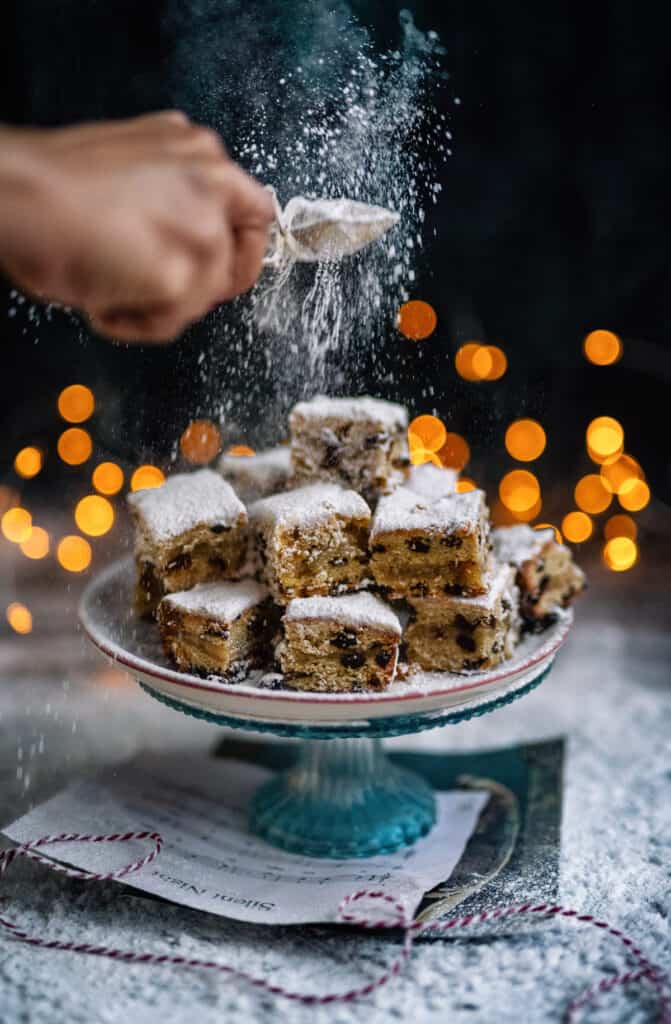 Dusting stollen bites with icing sugar