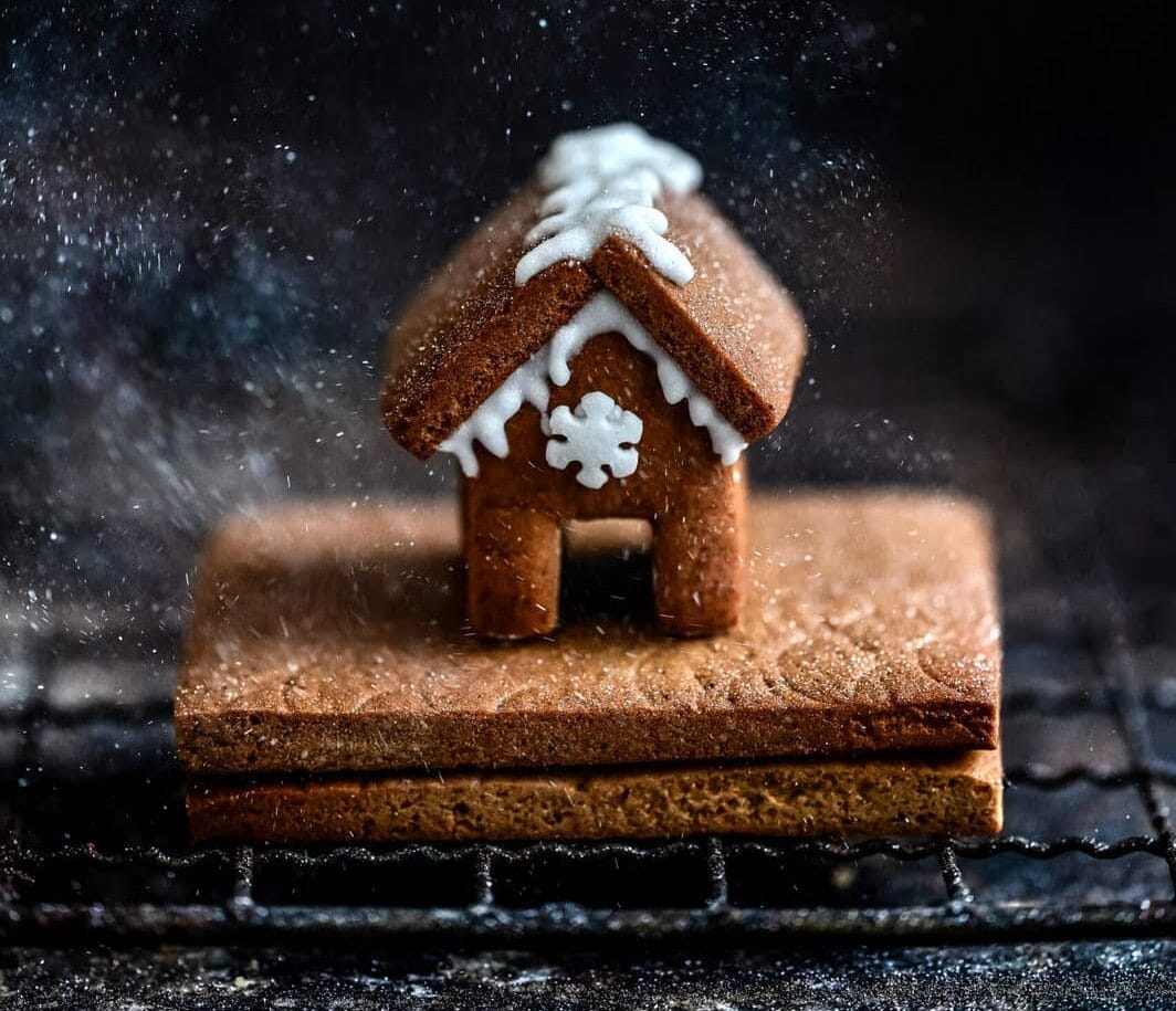 Tiny gingerbread house against a dark background