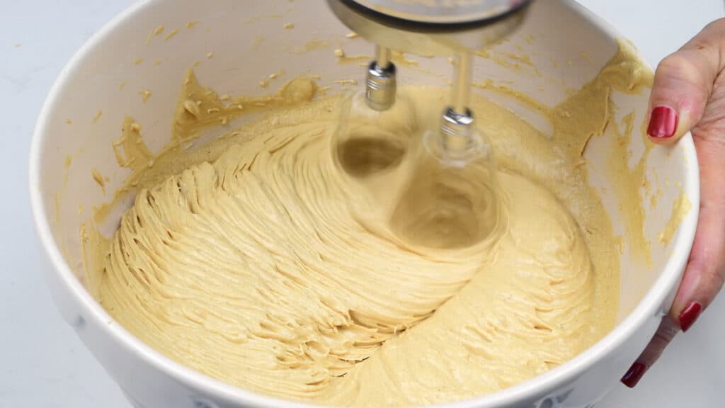 beating gingerbread cake batter with a hand mixer