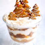 Gingerbread trifle in a glass bowl topped with cookies