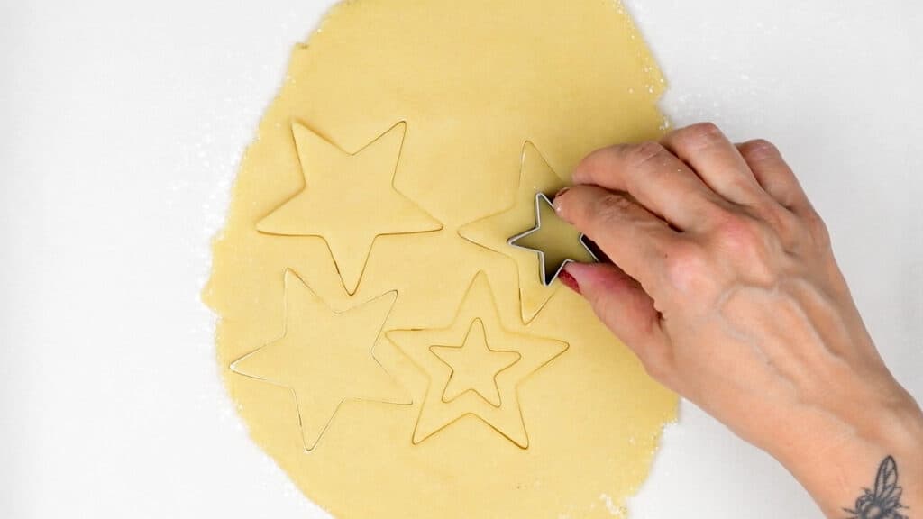 Cutting out star shaped sugar cookies