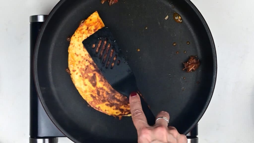 Pan frying birria taco