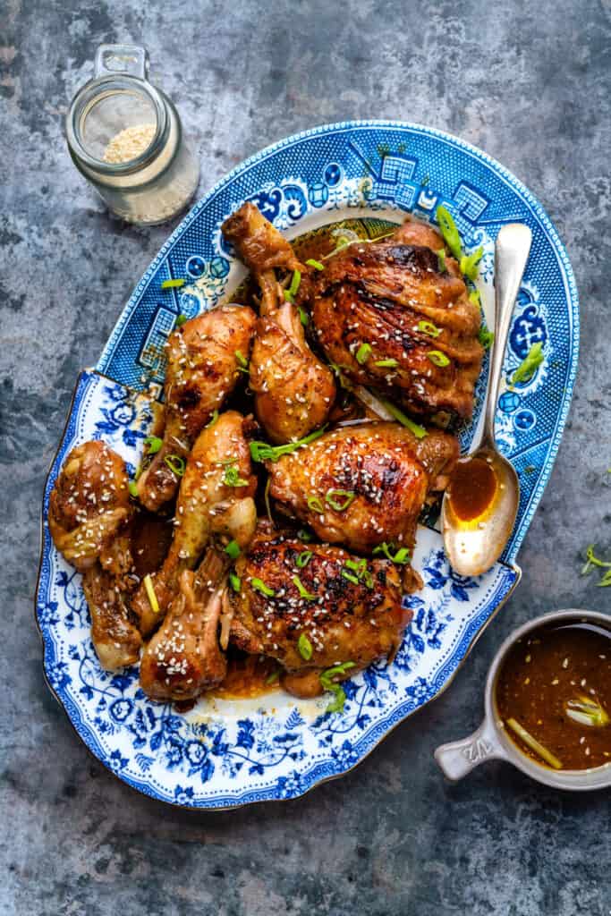 Platter of braised chicken thighs with green onions and sesame seeds