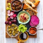 Vegan grazing platter with dips, fruit, vegetables, nuts and bread