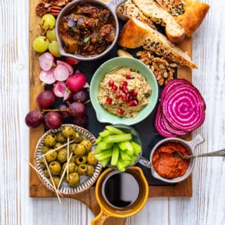 Vegan grazing platter with dips, fruit, vegetables, nuts and bread