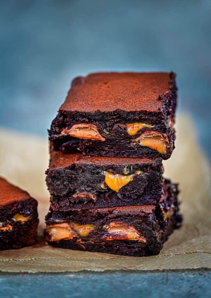 Three squares of chocolate brownies stuffed with caramel