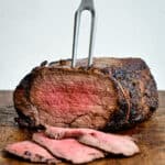 Air fryer Roast beef on a wooden board with slices cut