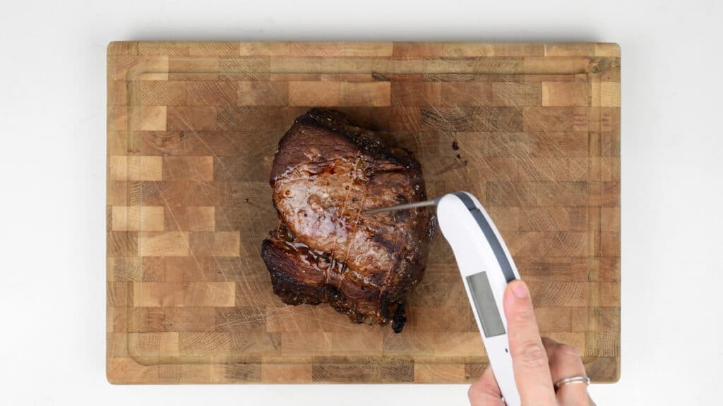 Checking beef roast internal tempeature with an instant read thermometer