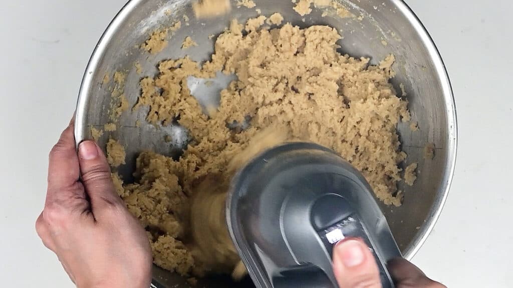 mixing cookie dough with an electric hand mixer