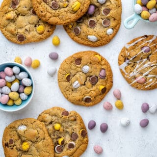 Easter Mini Egg Cookies on a white background with Cadbury's mini eggs scattered around them