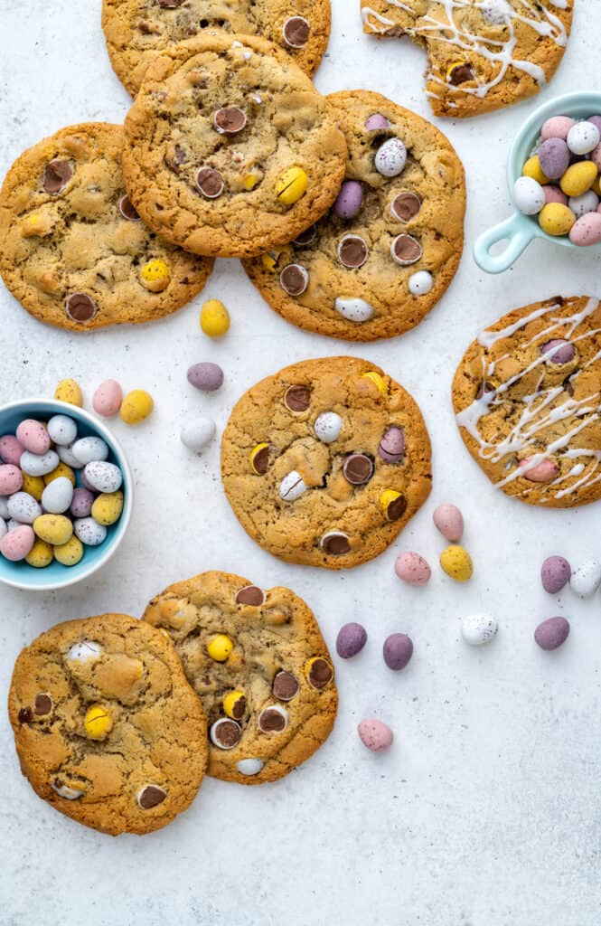 Easter Mini Egg Cookies on a white background with Cadbury's mini eggs scattered around them