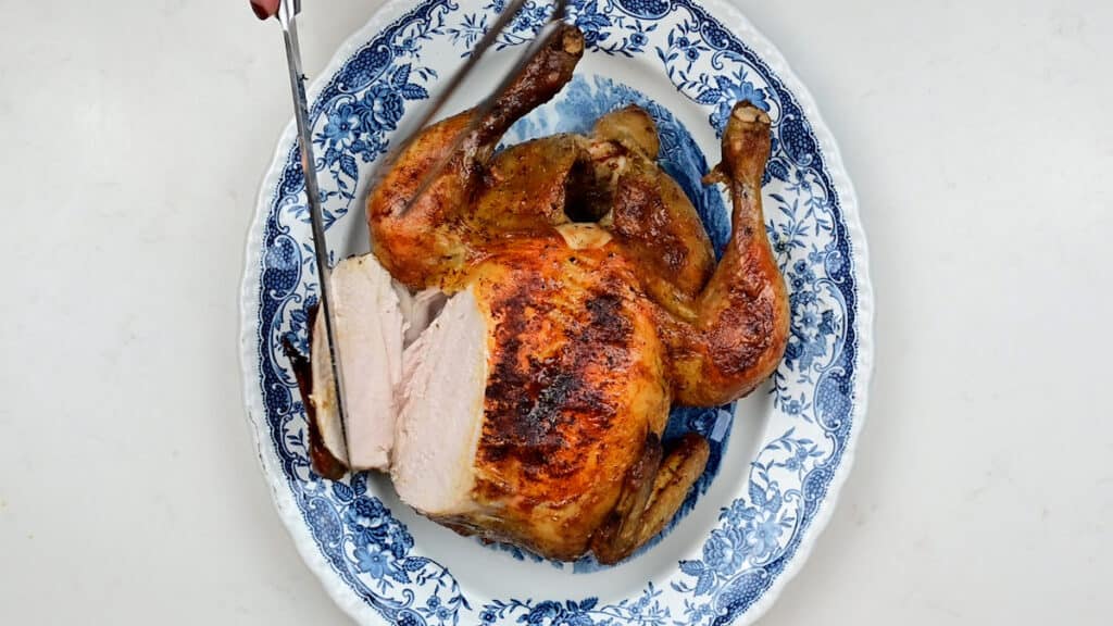 sliced pot roast chicken on a platter
