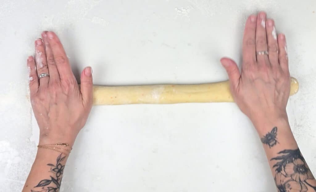 rolling bread dough into a long rope