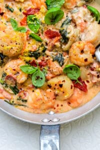 Tuscan Shrimp and Scallops in a rich creamy sauce with sun dried tomatoes and spinach