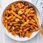 Large bowl of chicken and chorizo pasta in tomato sauce