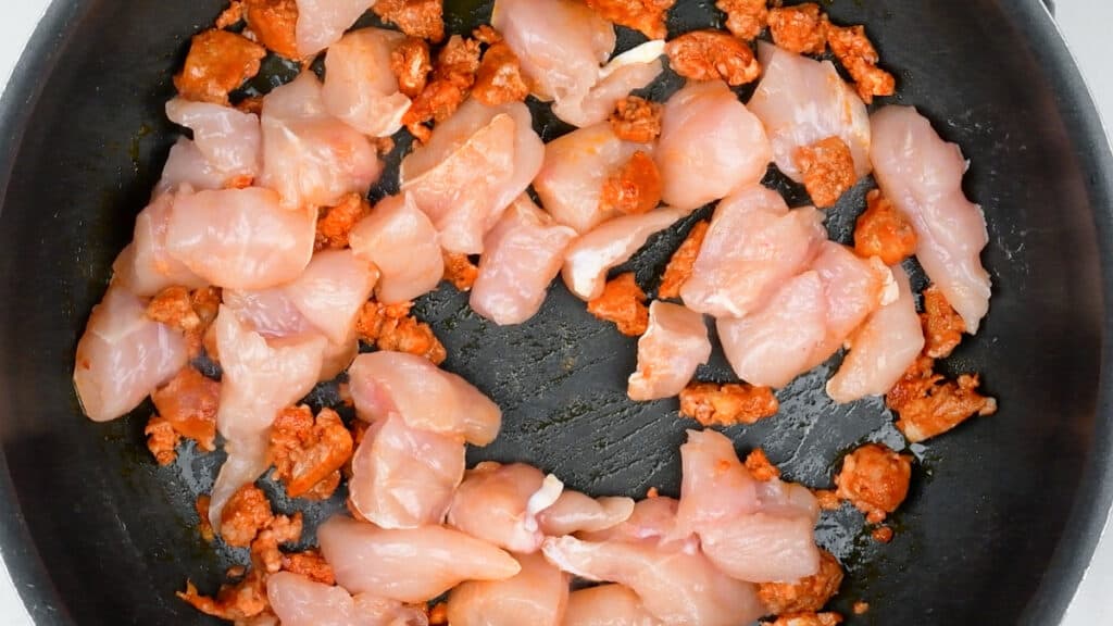 chorizo and chicken cooking in a pan
