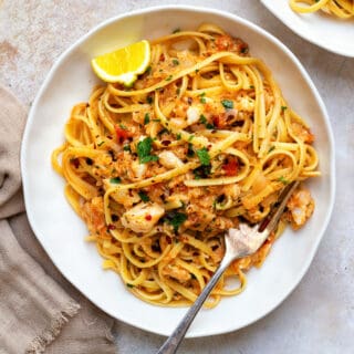 Serving of crab linguine in a white pasta bowl