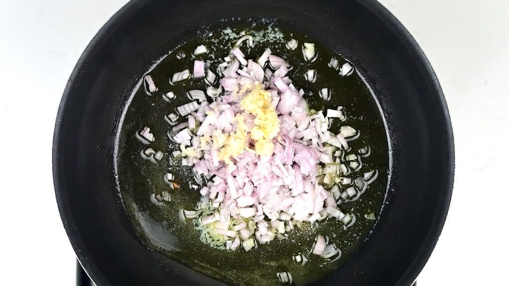 shallots and garlic cooking in a pan
