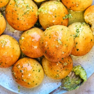 Close up on dough balls served with garlic butter on a plate
