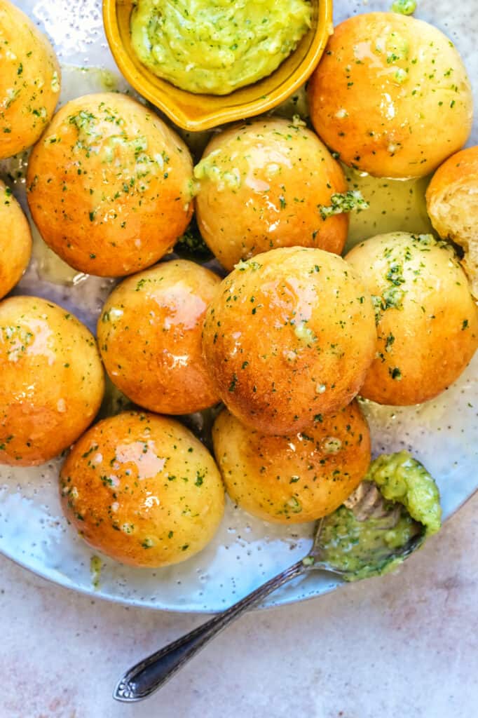Close up on dough balls served with garlic butter on a plate