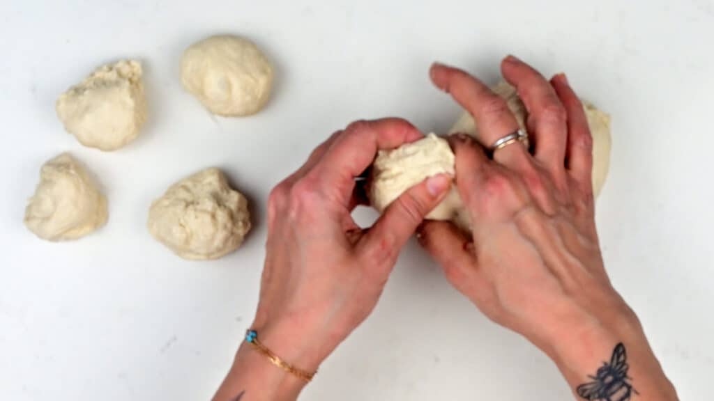 pinching small pieces of dough between fingers
