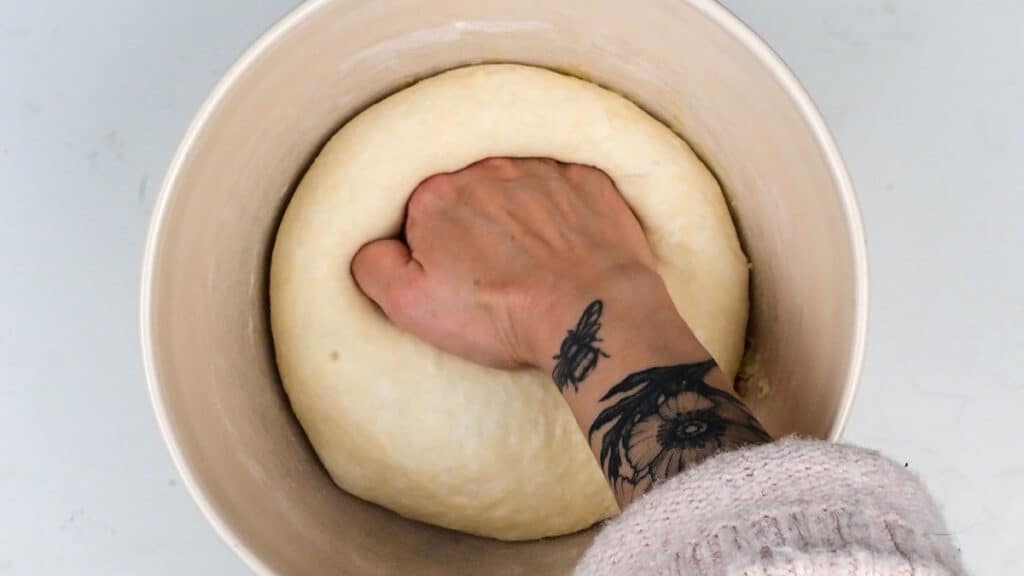 Punching dough to deflate