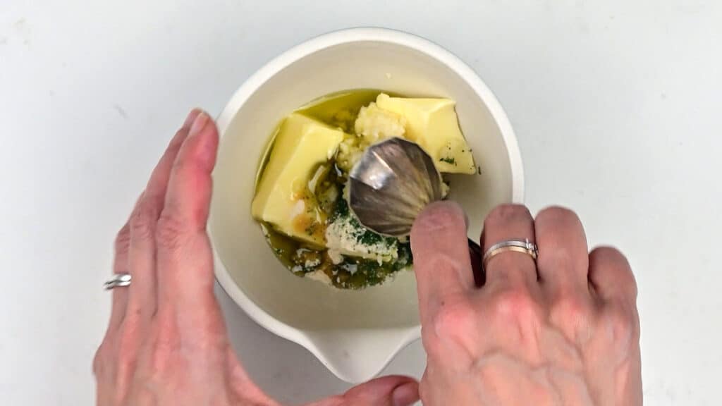 preparing garlic butter in a small bowl