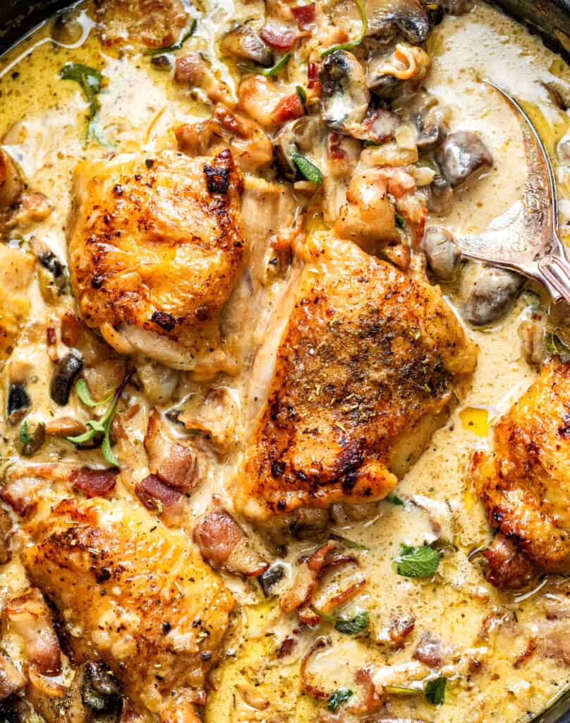 Chicken thighs in a creamy sauce with mushrooms, herbs and bacon