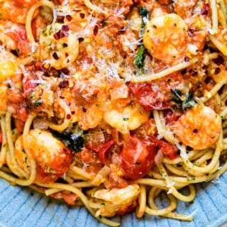 Close up on a bowl of prawn pasta with tomatoes and chorizo