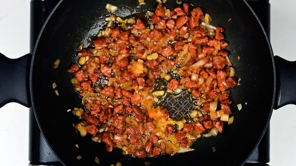 chorizo, shallots and garlic cooking in a pan