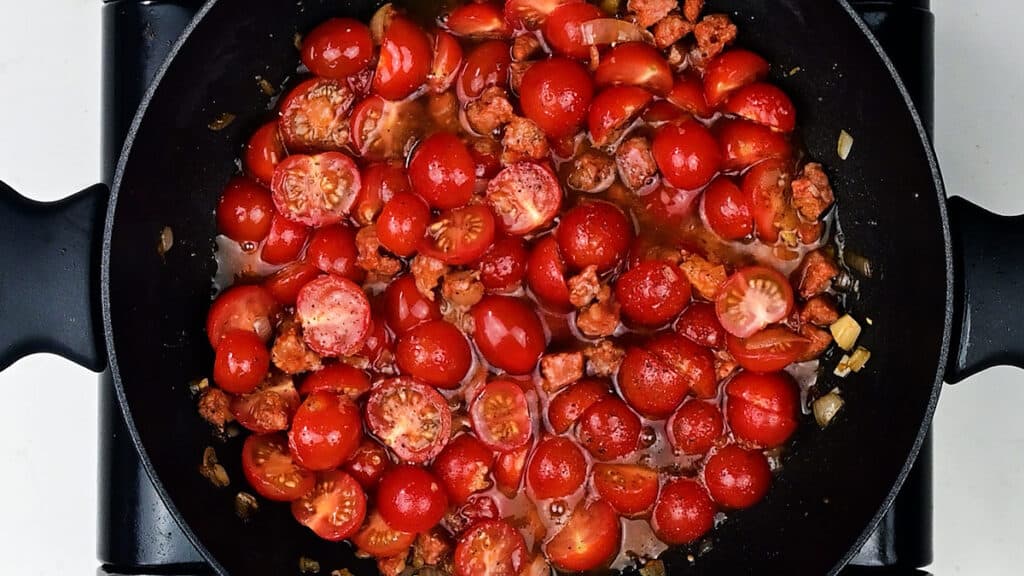 Cherry tomatoes cooking in a pan