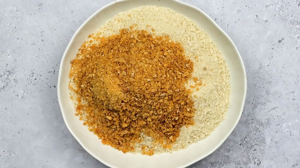 Panko breadcrumbs and crushed cornflakes in a shallow bowl