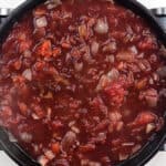 tomato sauce with red wine simmering in a pan