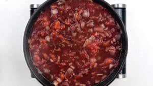 tomato sauce with red wine simmering in a pan
