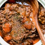 Close up on beef pot roast with tomatoes and carrots