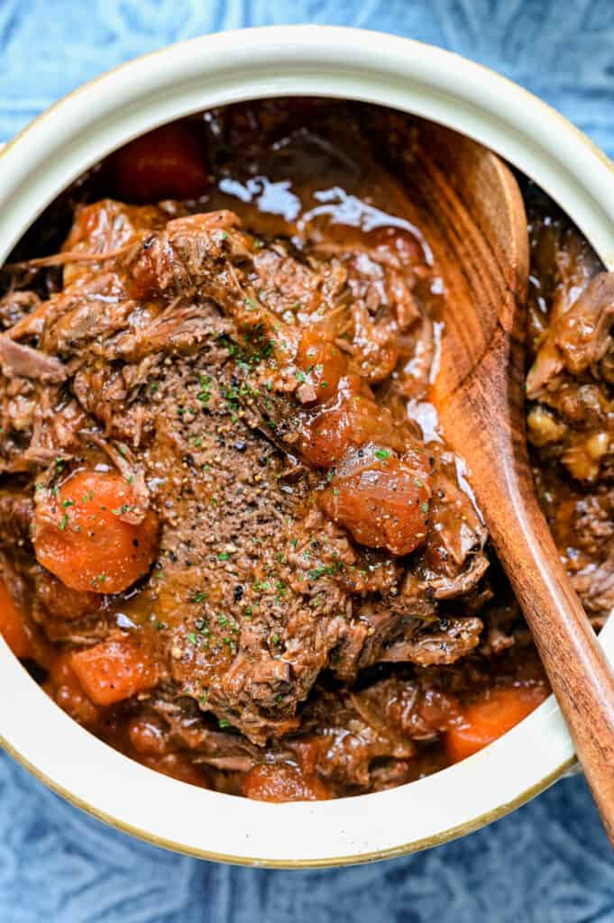 Close up on beef pot roast with tomatoes and carrots