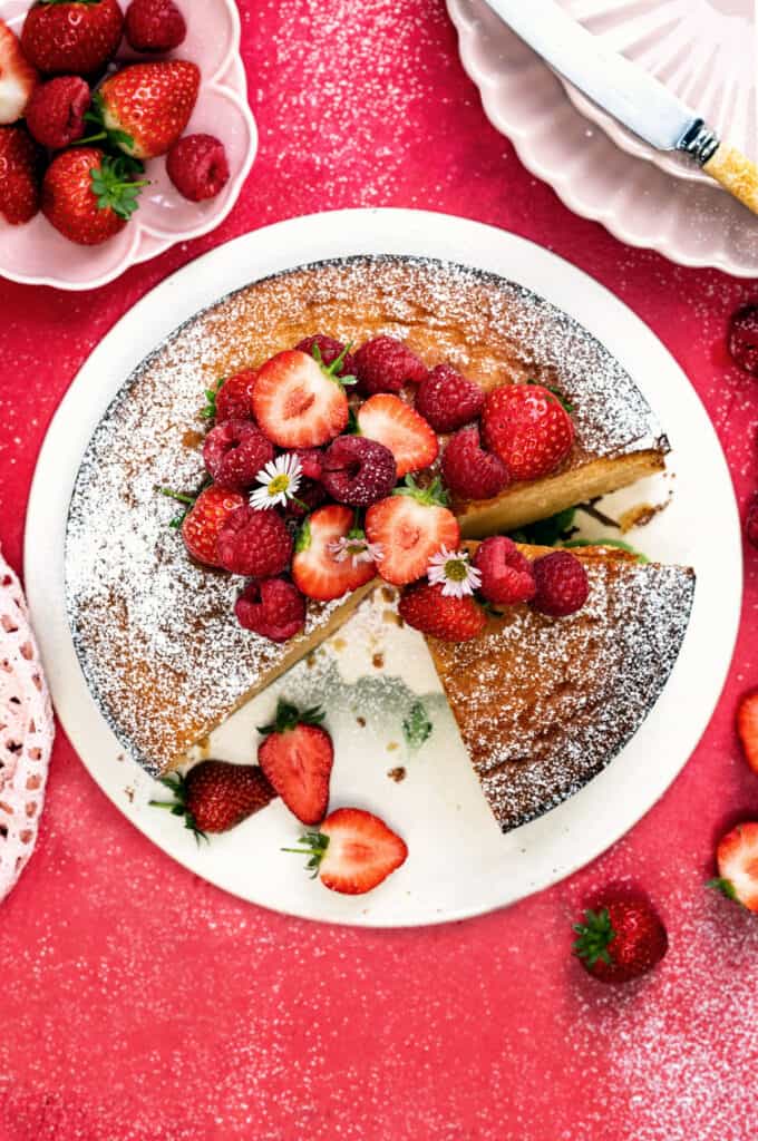 Condensed milk cake, sliced, topped with strawberries and raspberries