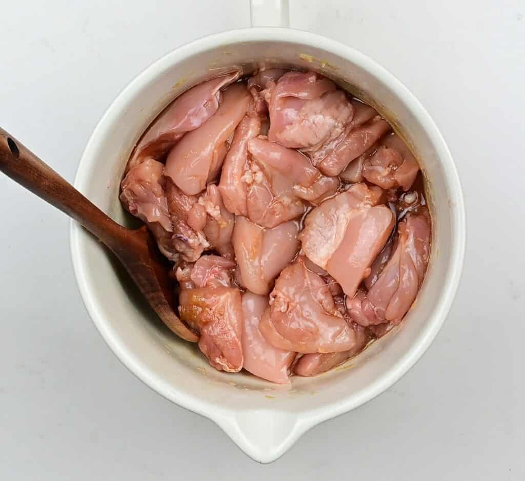 chicken thighs marinating in a bowl