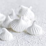 Meringue cookies on a white textured background