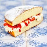 Sandwich sponge cake with jam, strawberries and cream
