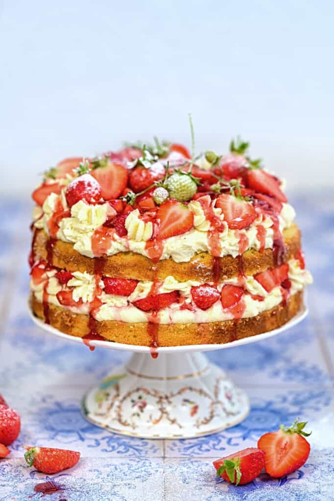 Strawberry Shortcake Layer cake with fresh strawberries and cream on a cake stand