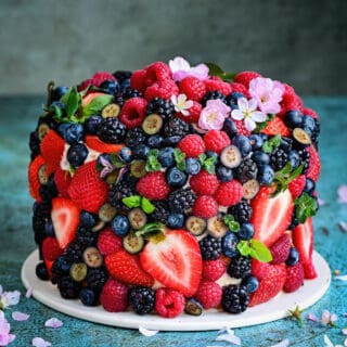 Berry cake covered with strawberries, blueberries, raspberries and blackberries