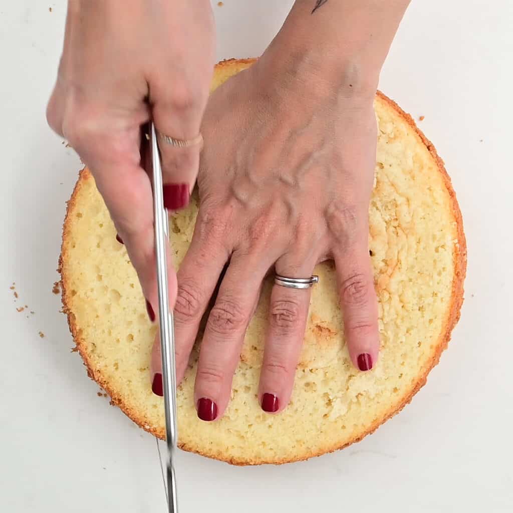 Using cake leveler to slice a sponge cake in half