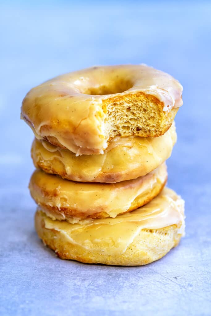 Stack of air fryer donuts, one with a bite taken out