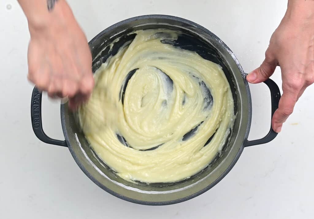 mixing donut glaze in a pot